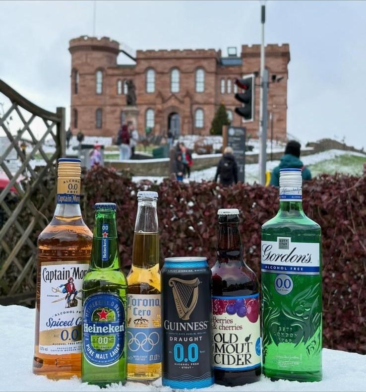 Alcohol-free drinks with a snowy view of Inverness Castle