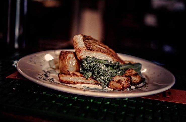 Fish served with potatoes and seasonal greens